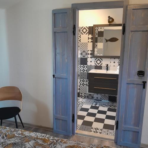 a bathroom with a blue door and a sink at MARANGUN Drage apartman in Drage