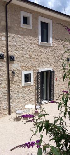 a stone building with a table in front of it at B&B Casa Anaceta in Villalago