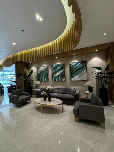 a lobby with couches and a table in a building at Makati apartment - Lush Residences in Manila