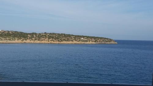 an island in the middle of a large body of water at Pergola Hotel in Agios Nikolaos