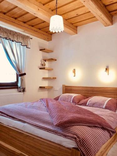 a bedroom with a bed and a window at U Johanky in Terchová
