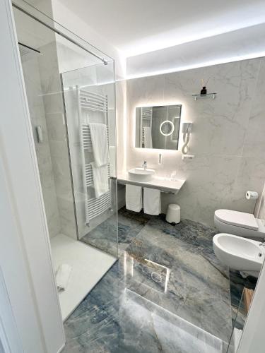 a bathroom with a sink and a toilet and a shower at Adagio Salentino in Porto Cesareo