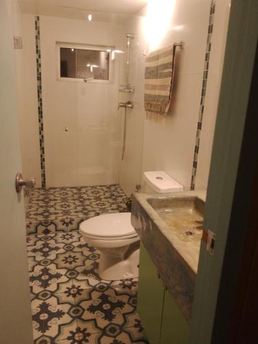 a bathroom with a toilet and a sink at casa Wamani in Santiago