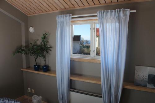 a window with white curtains in a room at Brygghuset Mollösund in Mollösund