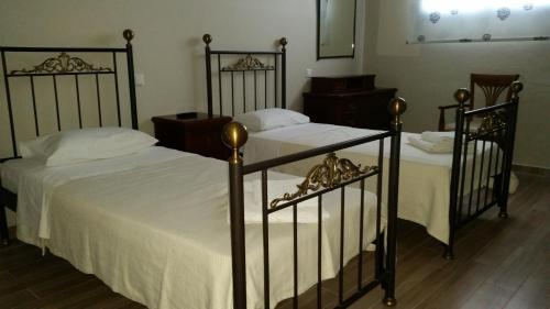 two beds sitting next to each other in a bedroom at Pergola Hotel in Agios Nikolaos