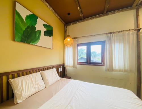 a bedroom with a white bed and a window at PIA homestay - Tours & Motorbike rentals - Cao Bằng in Cao Bằng