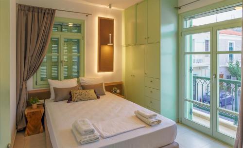 a bedroom with a bed and a large window at Paleochora Central Apartments in Palaiochóra