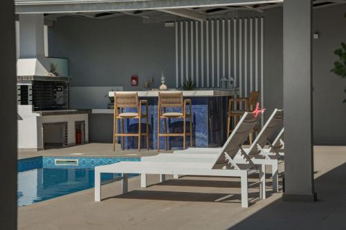 a kitchen with a table and chairs and a pool at Dareia Suites in Plános