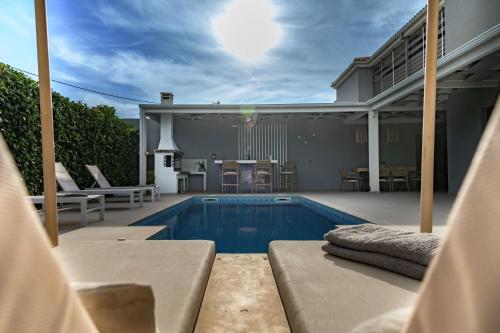 a house with a swimming pool in a backyard at Dareia Suites in Plános