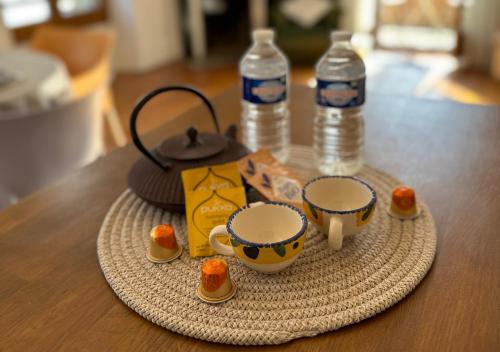 - une table avec deux tasses et deux bouteilles d'eau dans l'établissement Duplex Loft - Central & Home Cinéma, à Annecy
