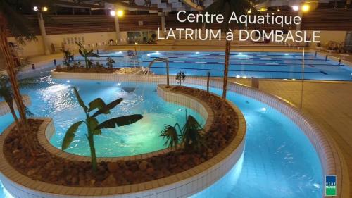 une grande piscine dans un grand bâtiment dans l'établissement Nid douillet aux portes de Nancy, à Varangéville