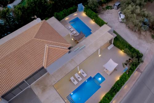 an overhead view of a house with two swimming pools at Dareia Suites in Plános