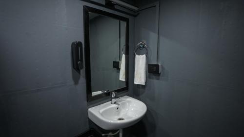 a bathroom with a sink and a mirror at Sort By Stays, Grand Peddem, Anjuna in Goa