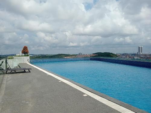 a swimming pool on the roof of a building at Legoland walk 3min D'Pristine Rejoice Suite 2B2R 8pax Lakeview in Nusajaya