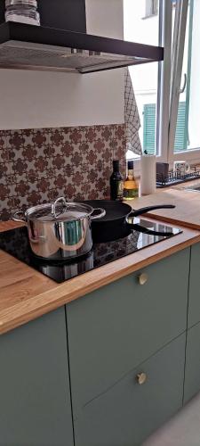 a kitchen counter with a pot on a stove at La Brignoletta Le Case del Dria Acquario suite in Genova