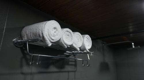 a row of towels on a rack in a bathroom at Sort By Stays, Grand Peddem, Anjuna in Goa