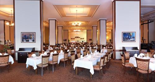 a dining room with white tables and chairs at Kaya Uludag in Uludag
