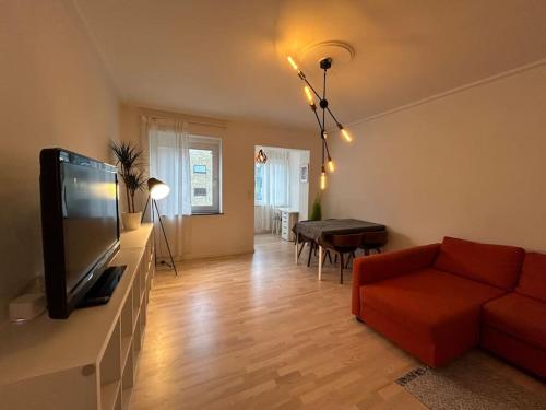a living room with a red couch and a flat screen tv at Dream Stay in Centre Copenhagen in Copenhagen