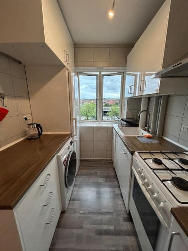 a small kitchen with a stove and a window at Dream Stay in Centre Copenhagen in Copenhagen
