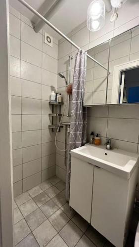 a white bathroom with a sink and a shower at Dream Stay in Centre Copenhagen in Copenhagen
