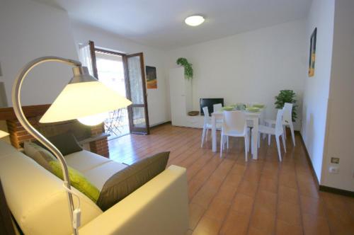 a living room with a couch and a table and chairs at Garibaldi in Stresa