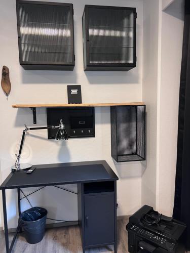 a black desk with a computer on a wall at Loviisan Helmi 102 in Lovisa