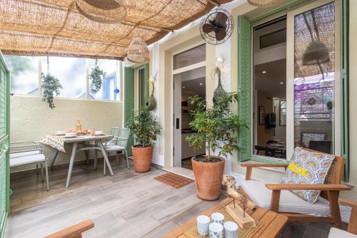 un patio avec une table, des chaises et des plantes dans l'établissement Villa fleurie, à Cagnes-sur-Mer
