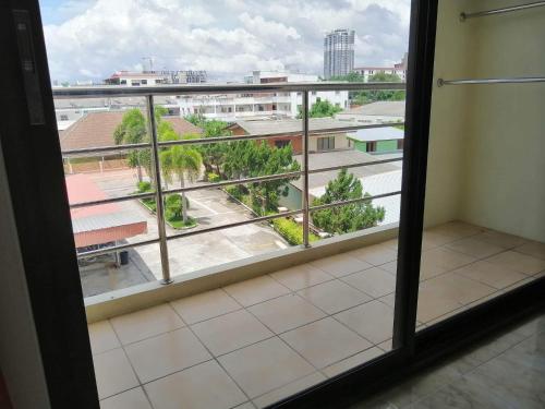 a room with a window with a view of a city at Pearl Place Hotel in Hat Yai