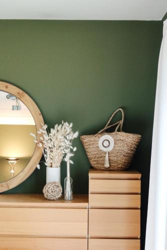 a room with a mirror and a dresser at La Chamallow Cœur d'Artichaud in Dinant