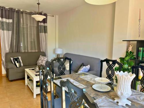 a living room with a table and a couch at Home4u Calle Barcelona in Armilla
