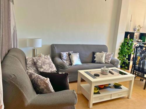 a living room with a couch and a coffee table at Home4u Calle Barcelona in Armilla