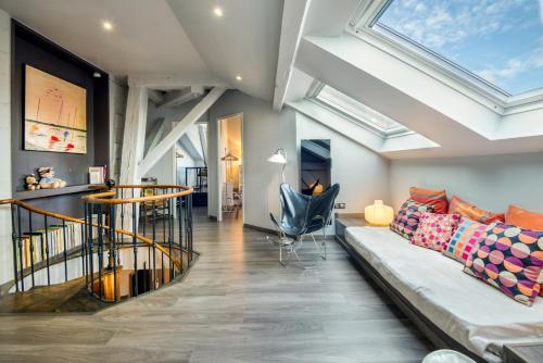 - un salon avec un canapé et des lucarnes dans l'établissement Duplex de 115m2 dans un bâtiment chic historique - Le Belvédère St Nicolas, à Nantes