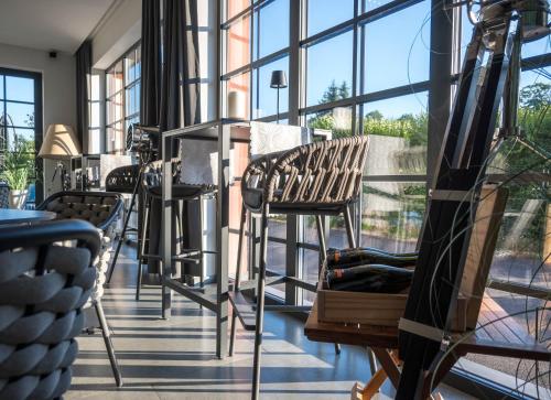 a room with chairs and a large window at Veltlin Bed & Wine in Valtice
