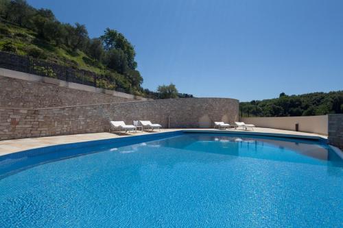 a large swimming pool with two lounge chairs at La Vista Azzurra in Lerici