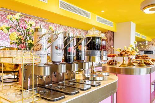 a kitchen with a counter with a bunch of coffee makers at Los Felices Ibiza in San Antonio Bay