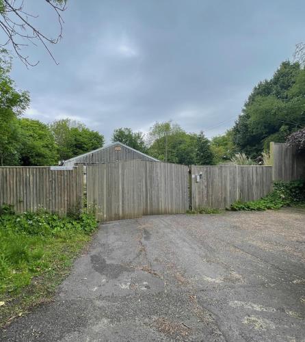 a wooden fence in front of a driveway at Tovey Lodge in Hassocks