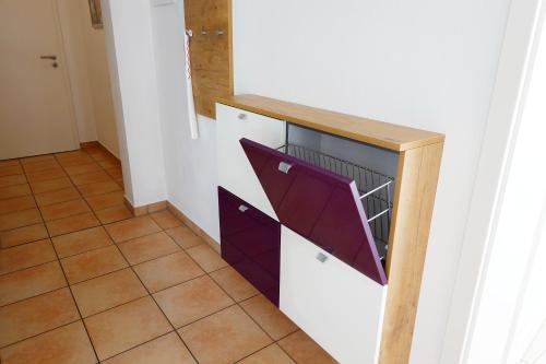a kitchen with a dishwasher with a purple door at Ferienwohnung im Goldtal in Bad Abbach