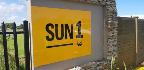a sign for the sun on the side of a fence at SUN1 Durban in Durban