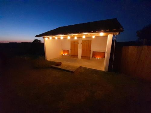 a small building with lights on it at night at Vacation Rental in Ambleville