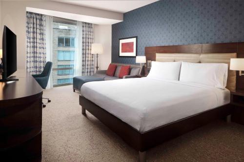 a hotel room with a bed and a couch at Hilton Garden Inn Washington DC/Georgetown Area in Washington