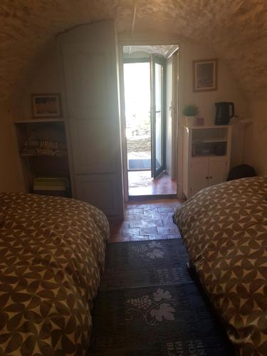 a bedroom with a bed and a door to a patio at Chambre indépendante au calme in Le Beausset