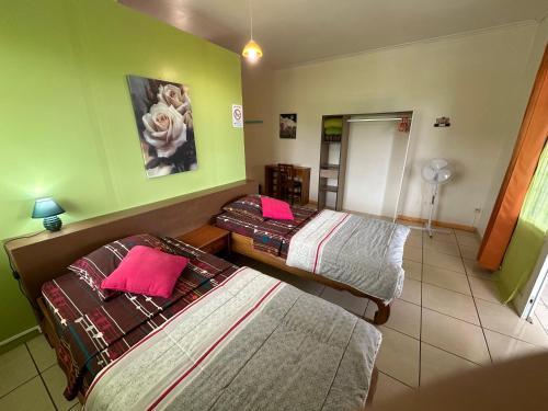 a hotel room with two beds and a mirror at Zoiseaux Paradis in Ravine des Cabris