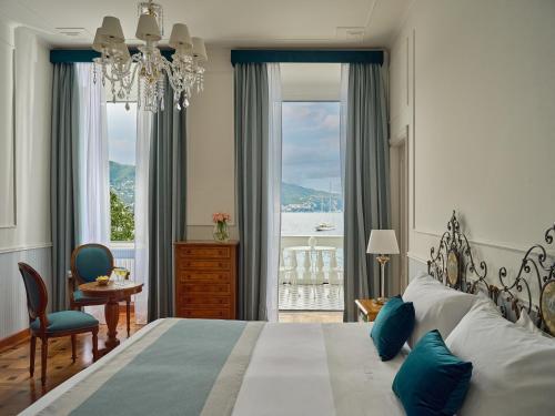a bedroom with a large bed with a large window at Grand Hotel Miramare in Santa Margherita Ligure