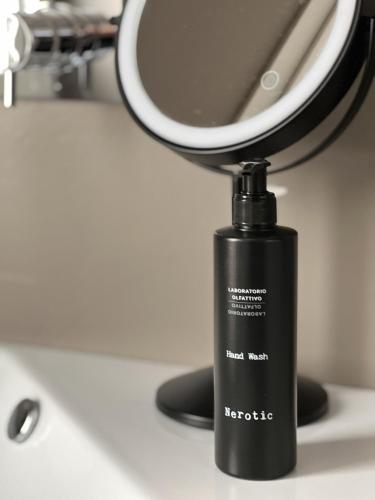 a black bottle on a counter with a mirror at LEONI DI COLLALTO PALACE in Treviso