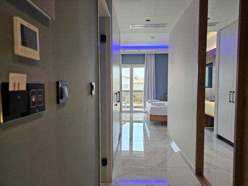 a hallway of a hotel room with a bedroom at AKTEON GIRNI in Paralia Katerinis