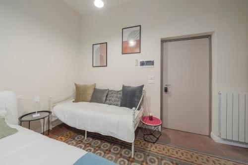 a bedroom with a bed and a door to a room at Loreto Prestige - Parking Free & Bulb Gym in Milan
