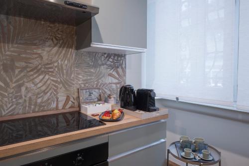 a kitchen with a counter with a bowl of fruit on it at Loreto Prestige - Parking Free & Bulb Gym in Milan
