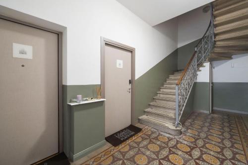 a hallway with a staircase and a door at Loreto Prestige - Parking Free & Bulb Gym in Milan