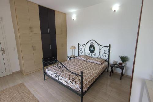 a bedroom with a bed and a dresser in it at Villa Luna Apartment in Vourliótai