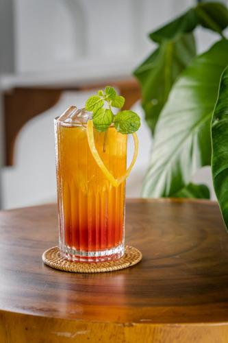 a glass of orange juice on a table at Arpana Luxury Private Pool Villas in Jimbaran